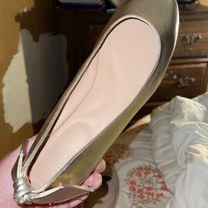 A pair of gold flats